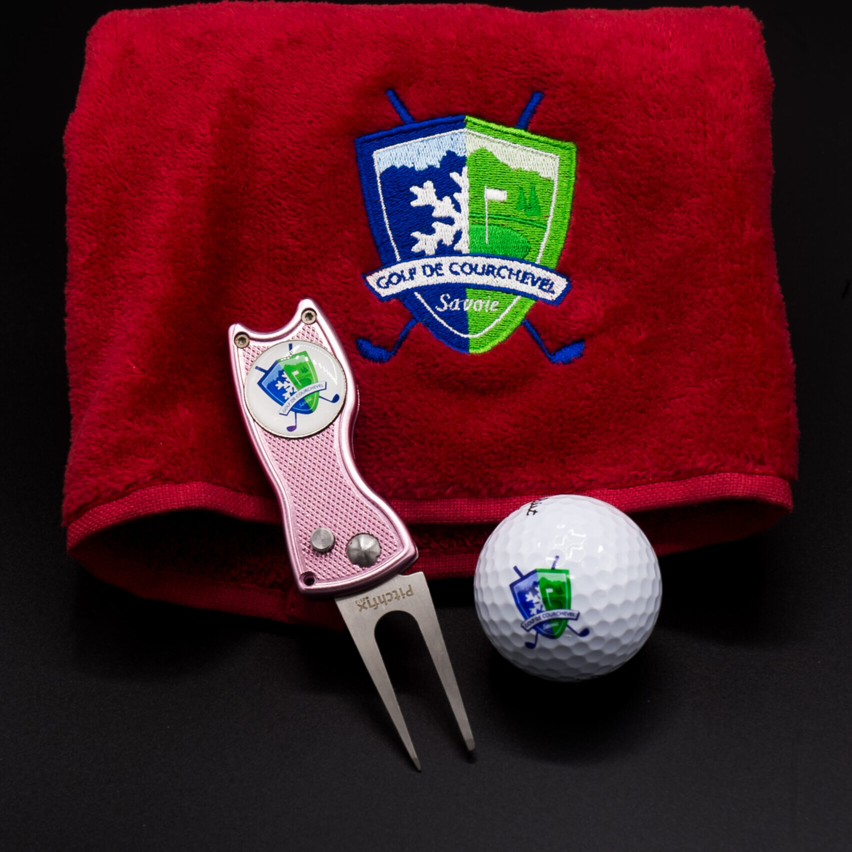 Golf towel, pitch mark repair tool and golf ball in the colours of the Courchevel Golf Club